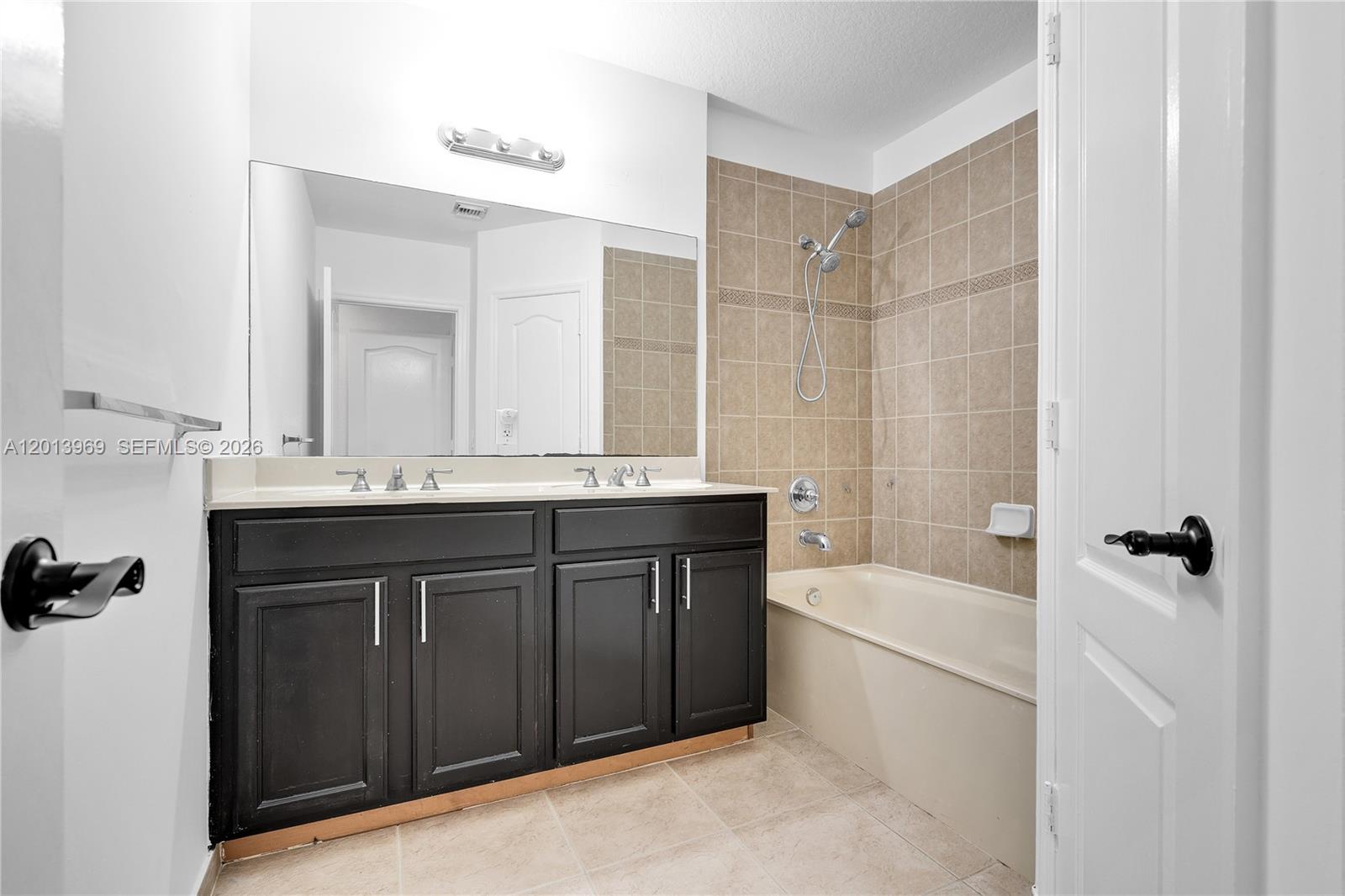 14044 Southwest 273rd Lane, Unit 14044 Homestead, FL 33032 - Photo 22 of 44 a bathroom with a sink vanity tub and shower