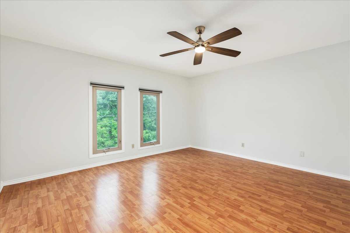 505 West 7th Street, Unit 313 Austin, TX 78701 - Photo 15 of 30 Empty room featuring light wood finished floors, baseboards, and ceiling fan