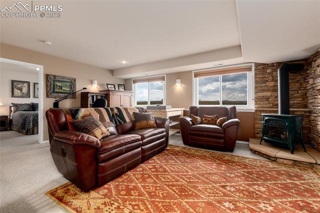 16850 Steppler Road Colorado Springs, CO 80908 - Photo 21 of 36 Lower family room with wood stove.