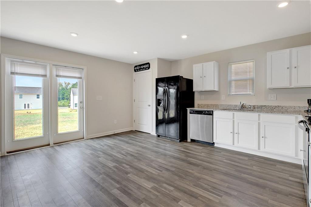 130 Catalpa Road Milner, GA 30257 - Photo 11 of 23 a view of an empty room with a kitchen and a window