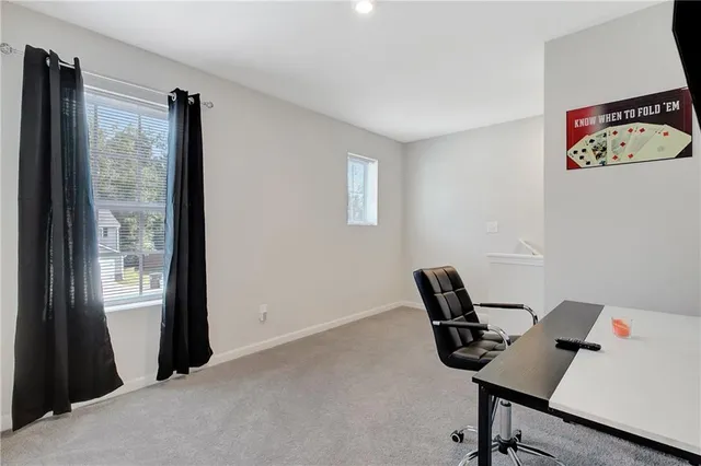 a bedroom with a bed and painting on the wall