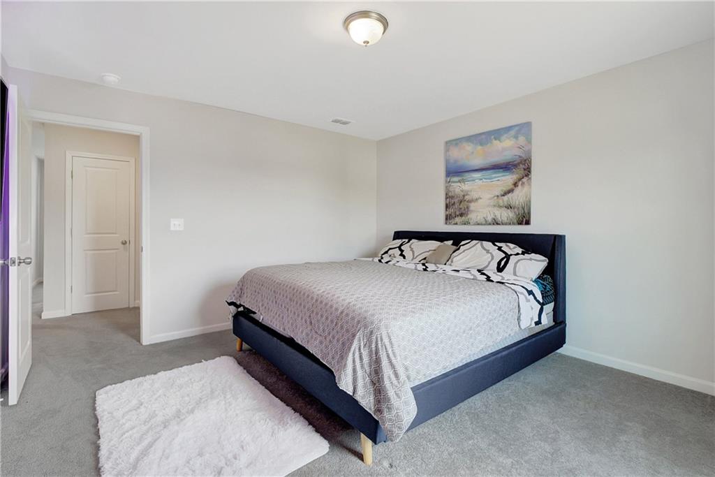 130 Catalpa Road Milner, GA 30257 - Photo 14 of 23 a bedroom with a bed and painting on the wall