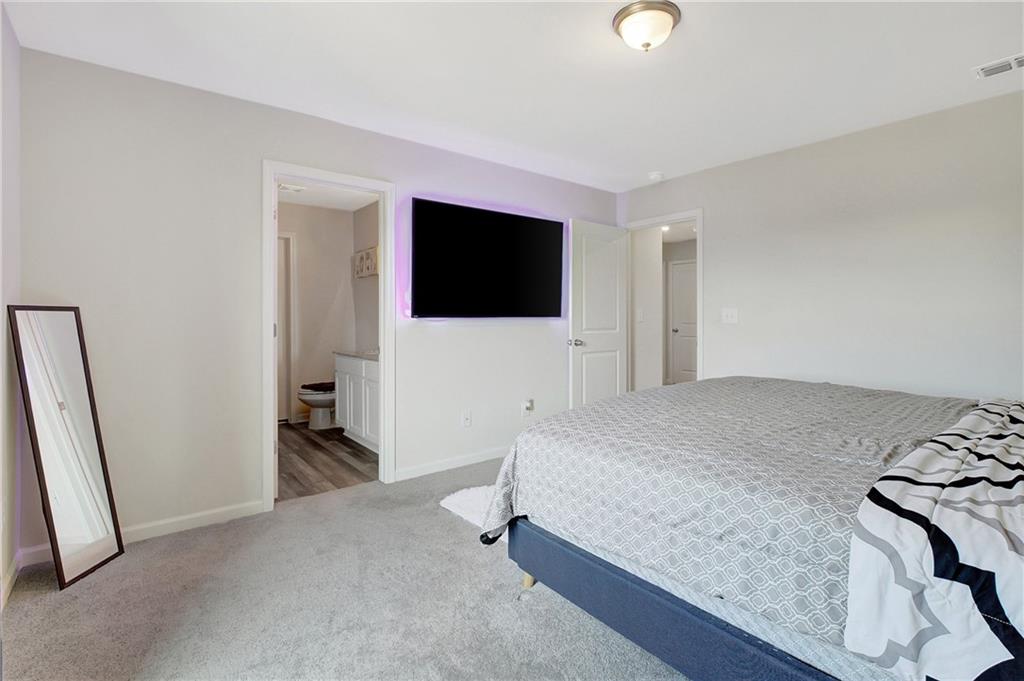 130 Catalpa Road Milner, GA 30257 - Photo 15 of 23 a bedroom with a bed and a flat screen tv