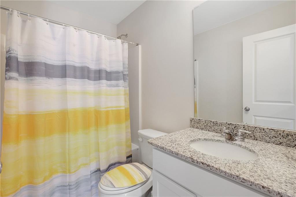 130 Catalpa Road Milner, GA 30257 - Photo 17 of 23 a bathroom with a granite countertop sink and a mirror