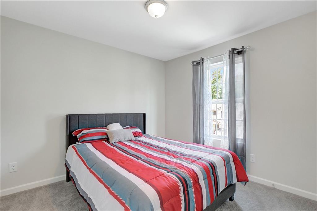 130 Catalpa Road Milner, GA 30257 - Photo 19 of 23 a bedroom with a bed and window