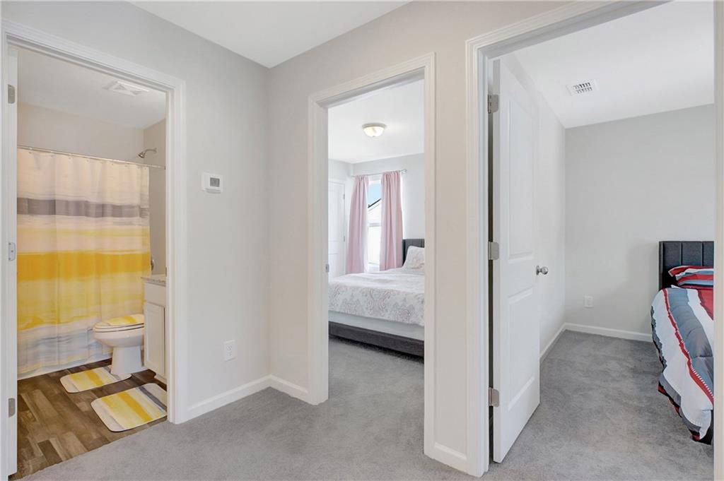 130 Catalpa Road Milner, GA 30257 - Photo 20 of 23 a view of a bedroom with a bed and wooden floor