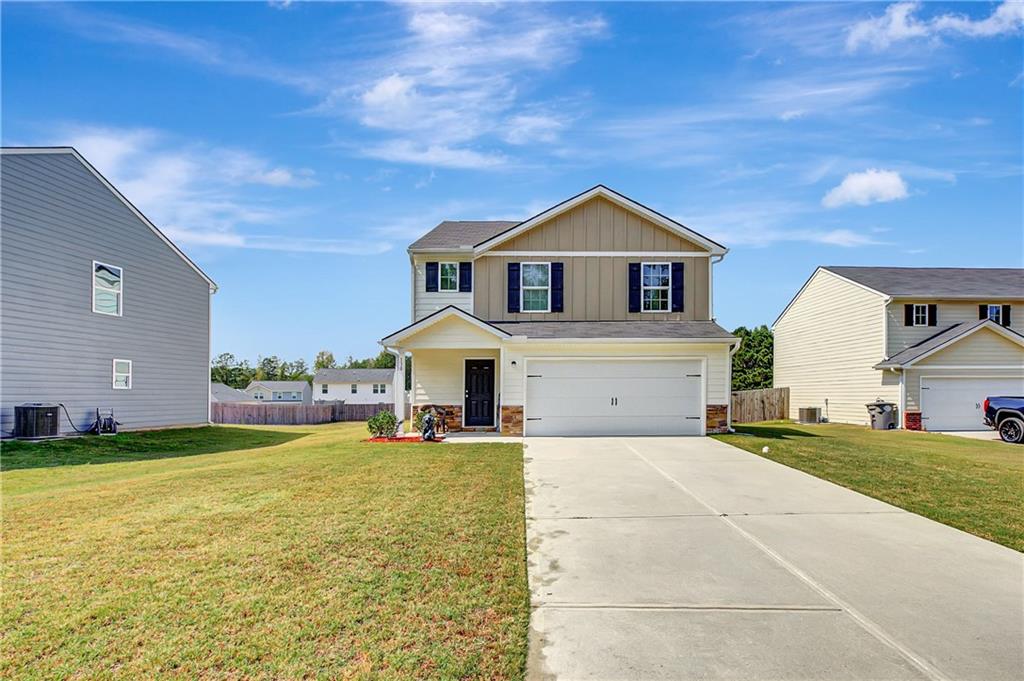 130 Catalpa Road Milner, GA 30257 - Photo 2 of 23 a front view of a house with a yard