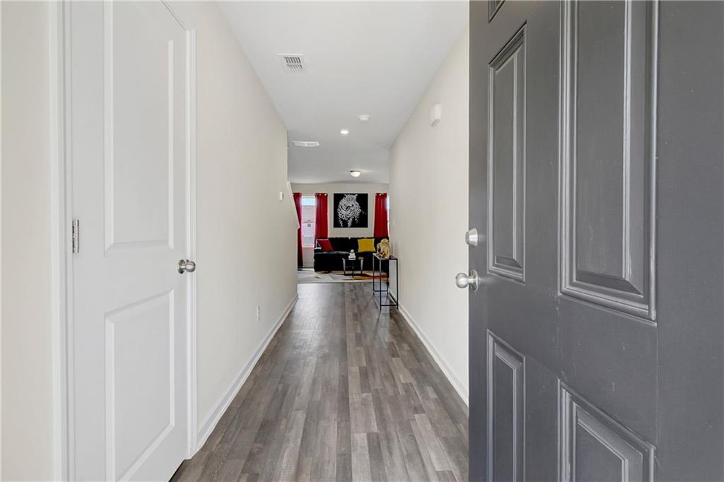 130 Catalpa Road Milner, GA 30257 - Photo 4 of 23 a view of a hallway with wooden floor and staircase