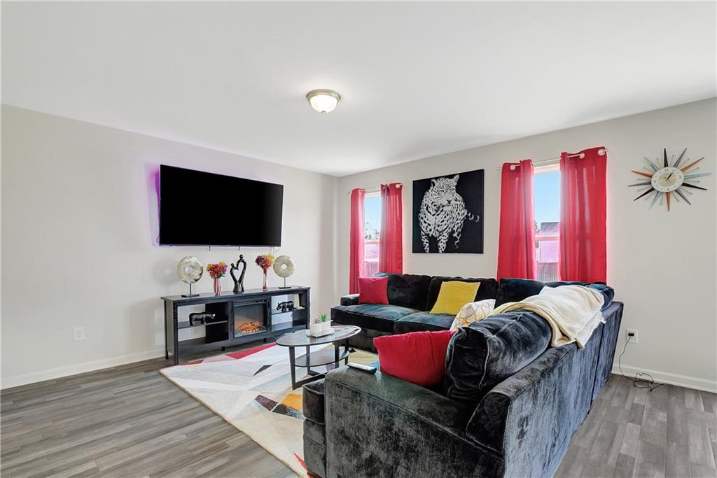 130 Catalpa Road Milner, GA 30257 - Photo 7 of 23 a living room with furniture and a flat screen tv