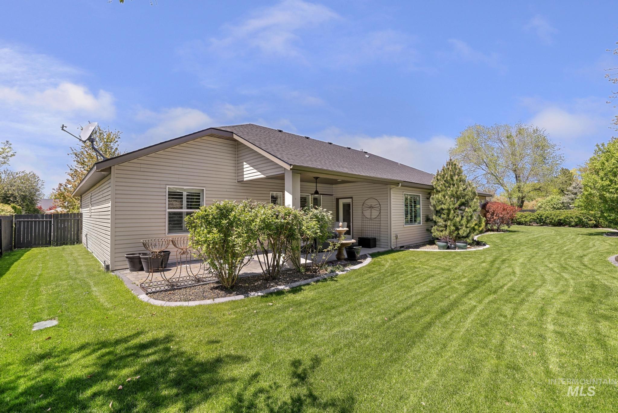 1937 Tamarack Loop Twin Falls, ID 83301 - Photo 40 of 50 Expansive backyard featuring a manicured lawn, established landscaping, and a covered patio