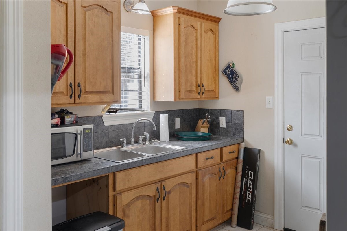 755 Mallard Street Hemphill, TX 75948 - Photo 11 of 27 a kitchen with stainless steel appliances granite countertop a sink a stove and a refrigerator