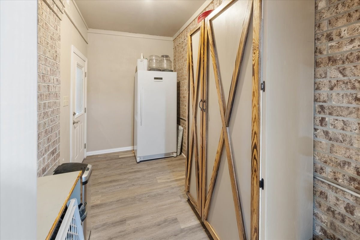 755 Mallard Street Hemphill, TX 75948 - Photo 12 of 27 a view of a hallway with wooden floor and entryway