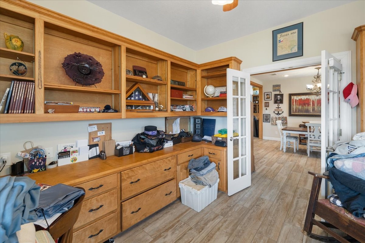 755 Mallard Street Hemphill, TX 75948 - Photo 13 of 27 a view of a kitchen with fridge and wooden floor