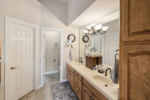 a bathroom with a double vanity sink mirror and shower