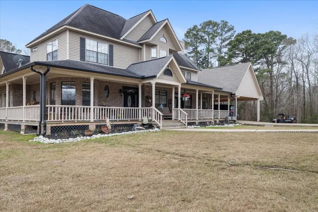 a front view of a house with a garden