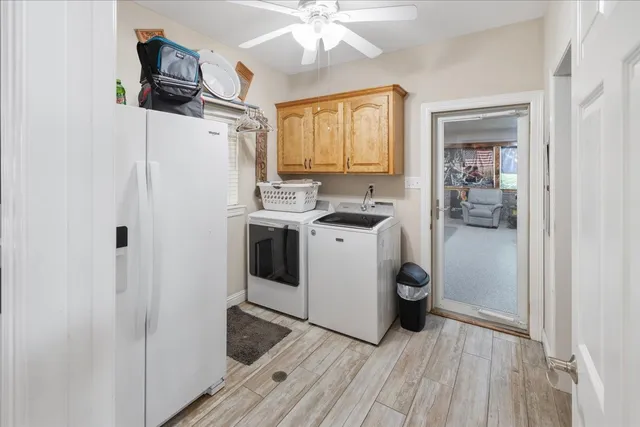 a utility room with cabinets washer and dryer