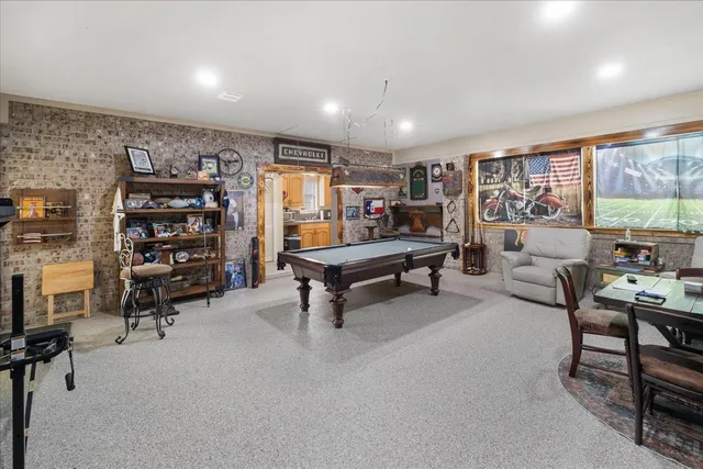 a living room with furniture a rug and gym equipment