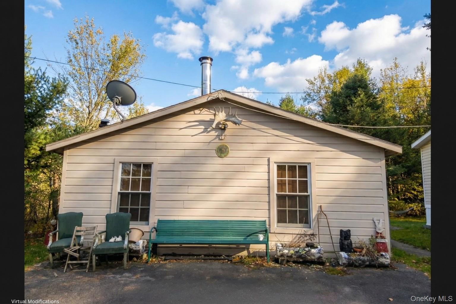 2032 Champlin Road Jefferson, NY 12093 - Photo 2 of 20 a backyard of a house with table and chairs