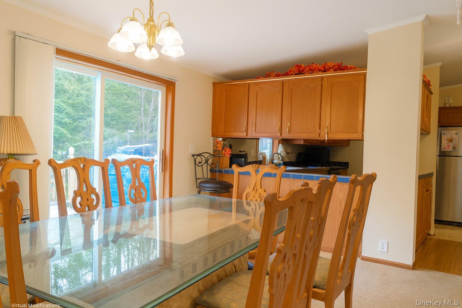 2032 Champlin Road Jefferson, NY 12093 - Photo 3 of 20 a view of a dining room with furniture a chandelier and a window