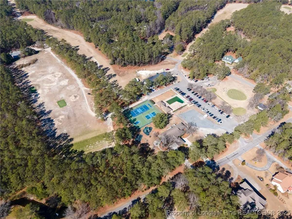 a view of a house with a yard covered in snow