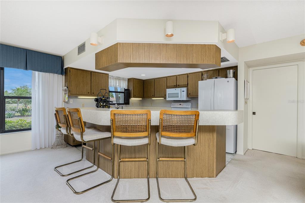3245 Sugarloaf Key Road, Unit 24A Punta Gorda, FL 33955 - Photo 11 of 52 a dinning room with chairs and view kitchen