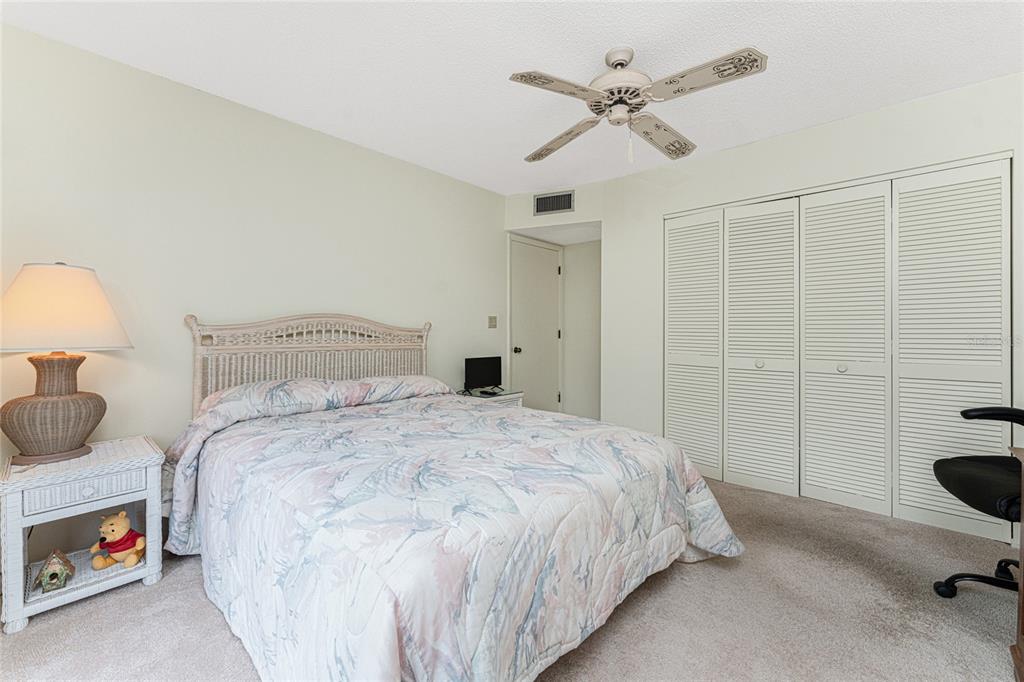 3245 Sugarloaf Key Road, Unit 24A Punta Gorda, FL 33955 - Photo 29 of 52 a bedroom with a bed and a chandelier