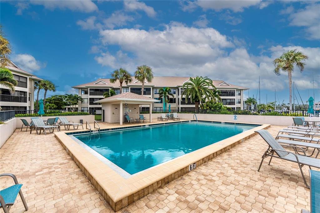 3245 Sugarloaf Key Road, Unit 24A Punta Gorda, FL 33955 - Photo 38 of 52 a view of a swimming pool with a lounge chairs