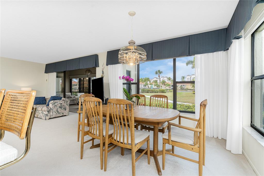 3245 Sugarloaf Key Road, Unit 24A Punta Gorda, FL 33955 - Photo 10 of 52 a view of a dining room with furniture window and wooden floor