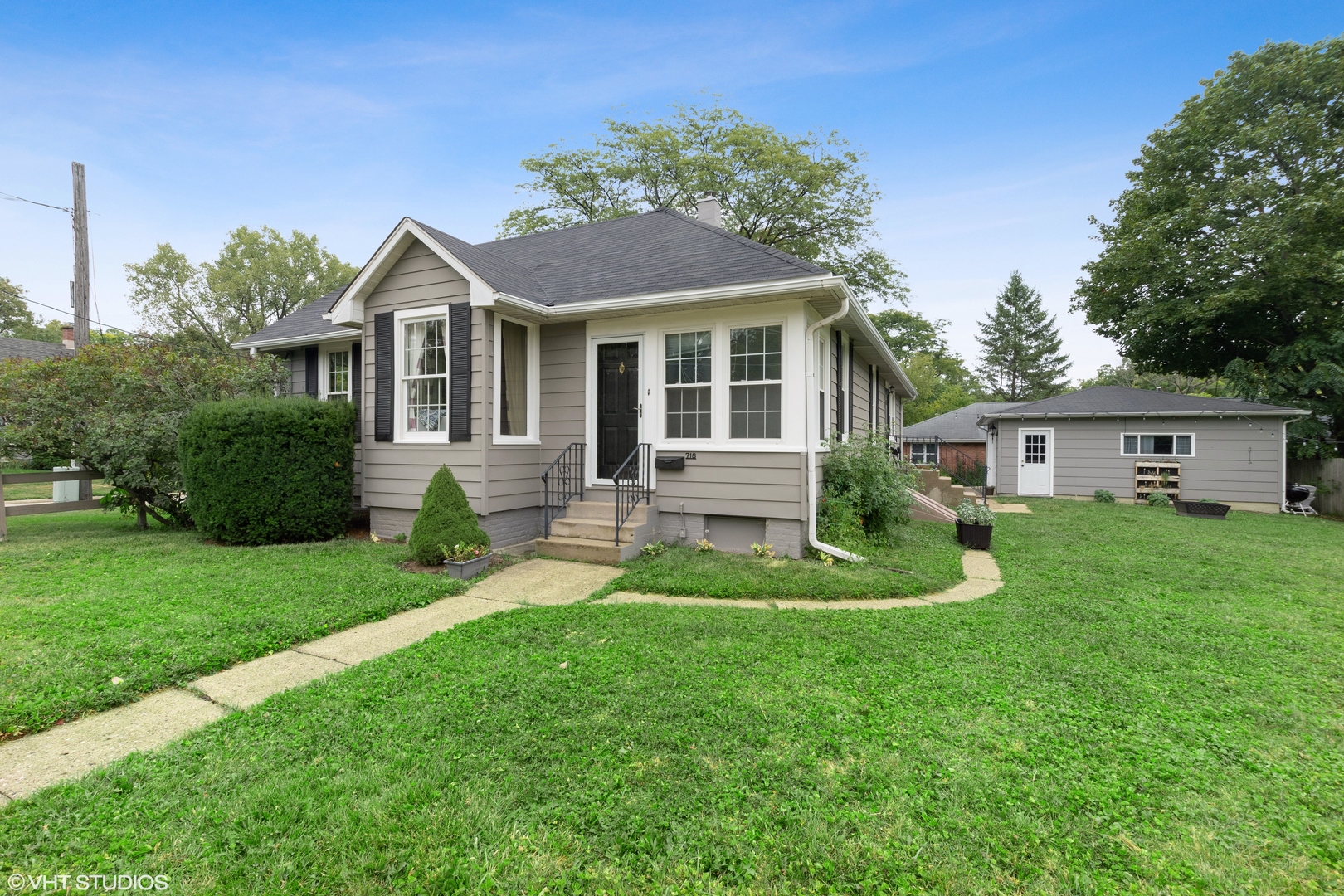 a front view of a house with a yard table and chairs