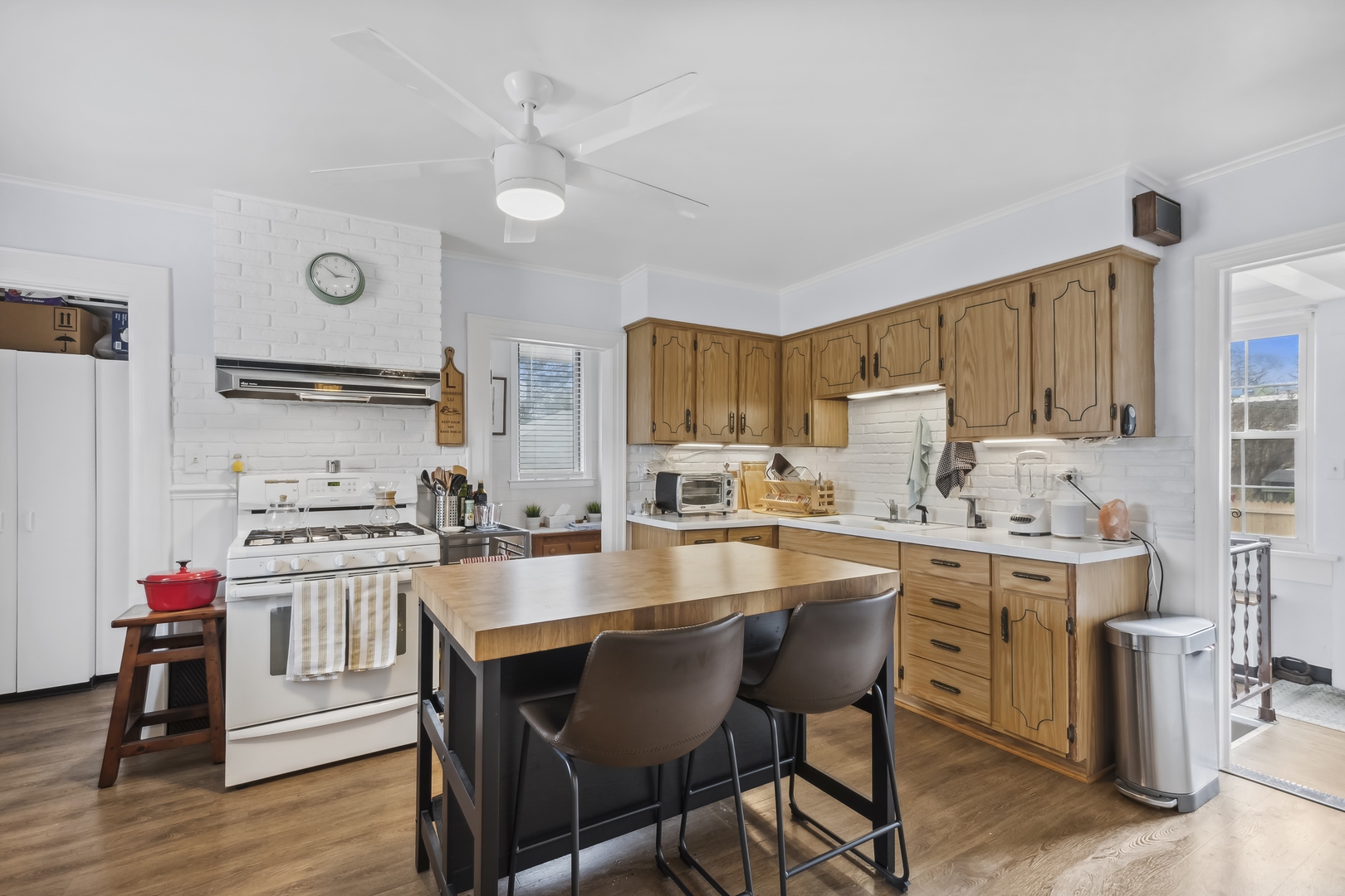 718 Sheridan Road Lake Bluff, IL 60044 - Photo 4 of 36 a kitchen with a dining table chairs refrigerator and cabinets