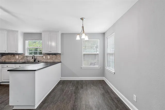 a kitchen with sink cabinets and window