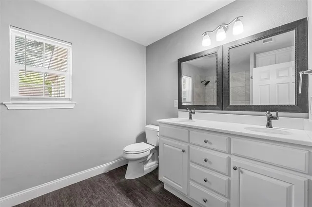 a bathroom with 2 sink and a mirror