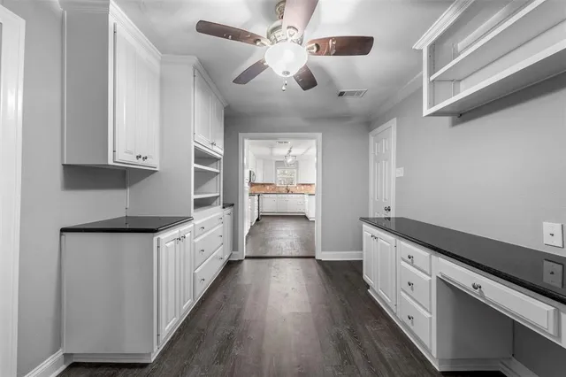 a kitchen with granite countertop a stove and a refrigerator