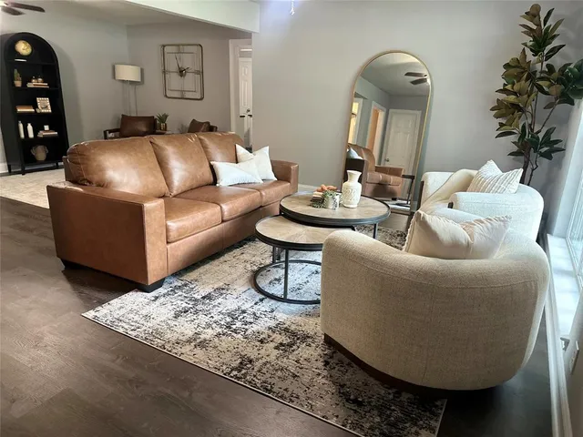 a living room with furniture and a potted plant