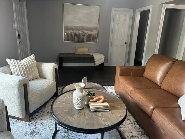 a living room with furniture and a mirror