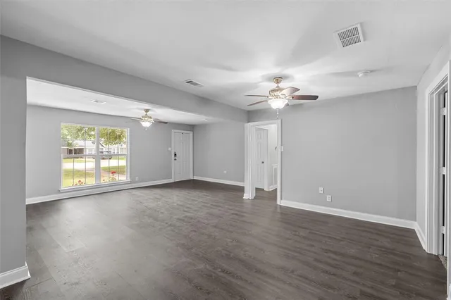 a view of a livingroom with a ceiling fan and window