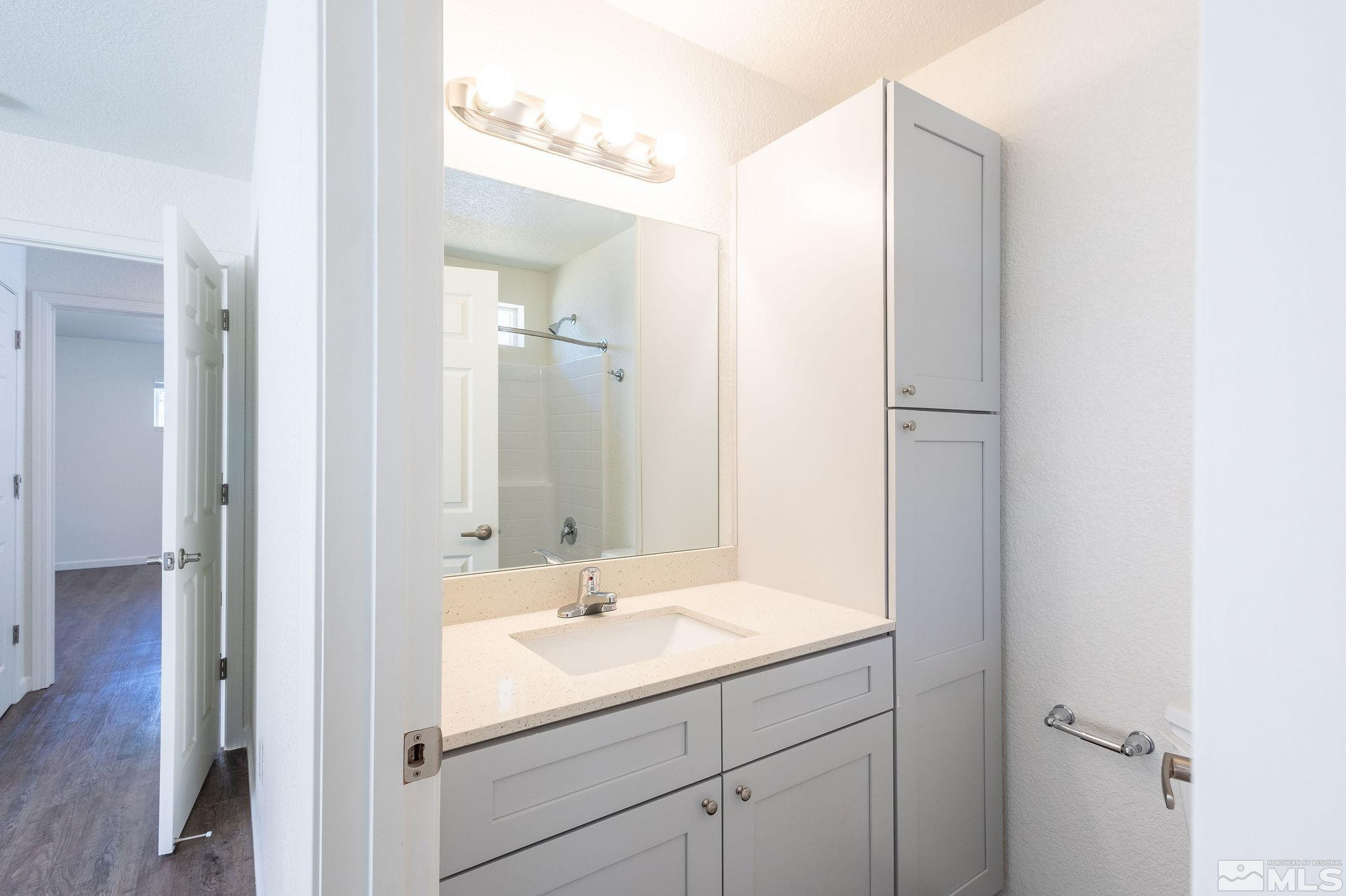 630 West 9th Street Reno, NV 89503 - Photo 18 of 20 a bathroom with a sink and a mirror