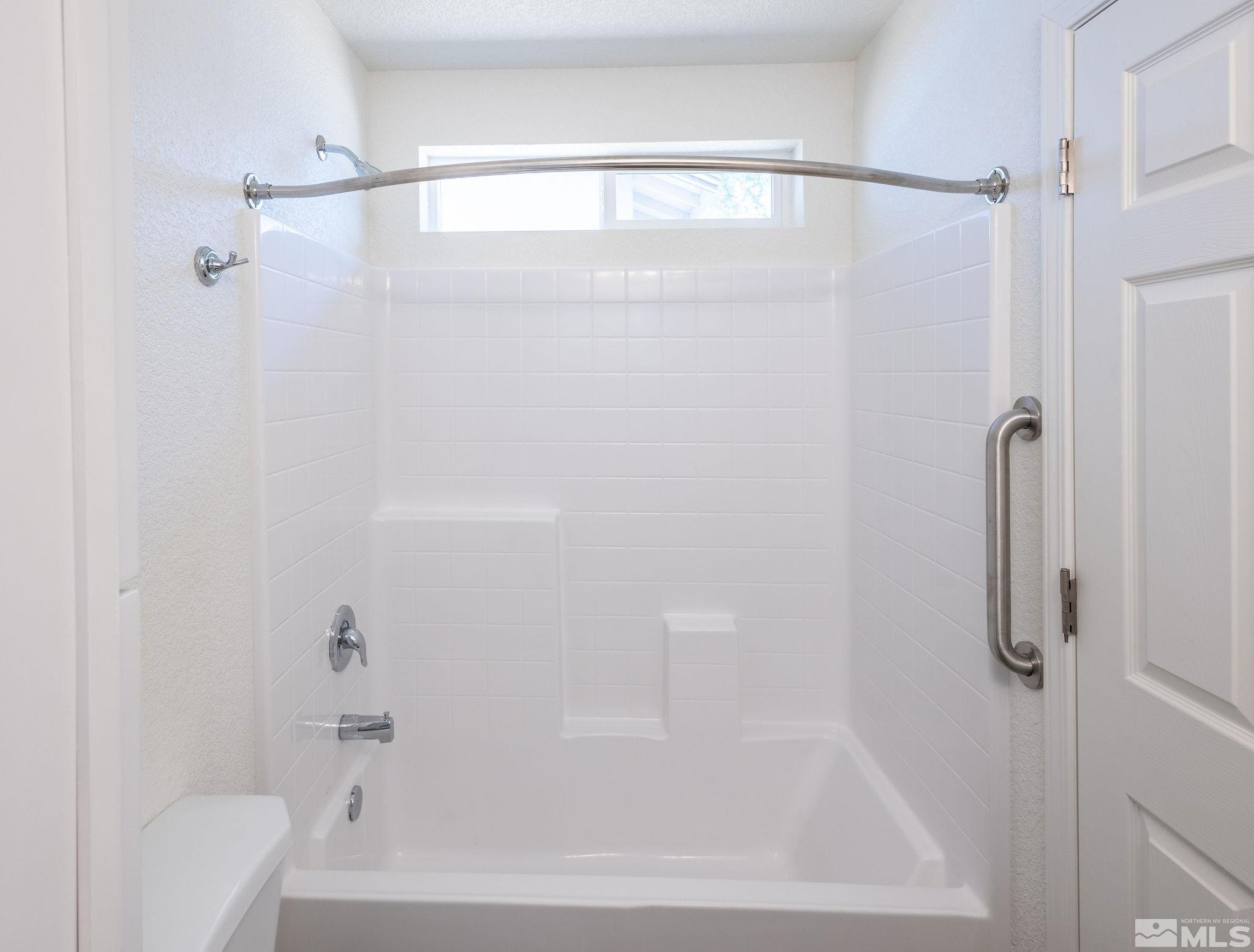 630 West 9th Street Reno, NV 89503 - Photo 20 of 20 a bathroom with a shower and a bath tub