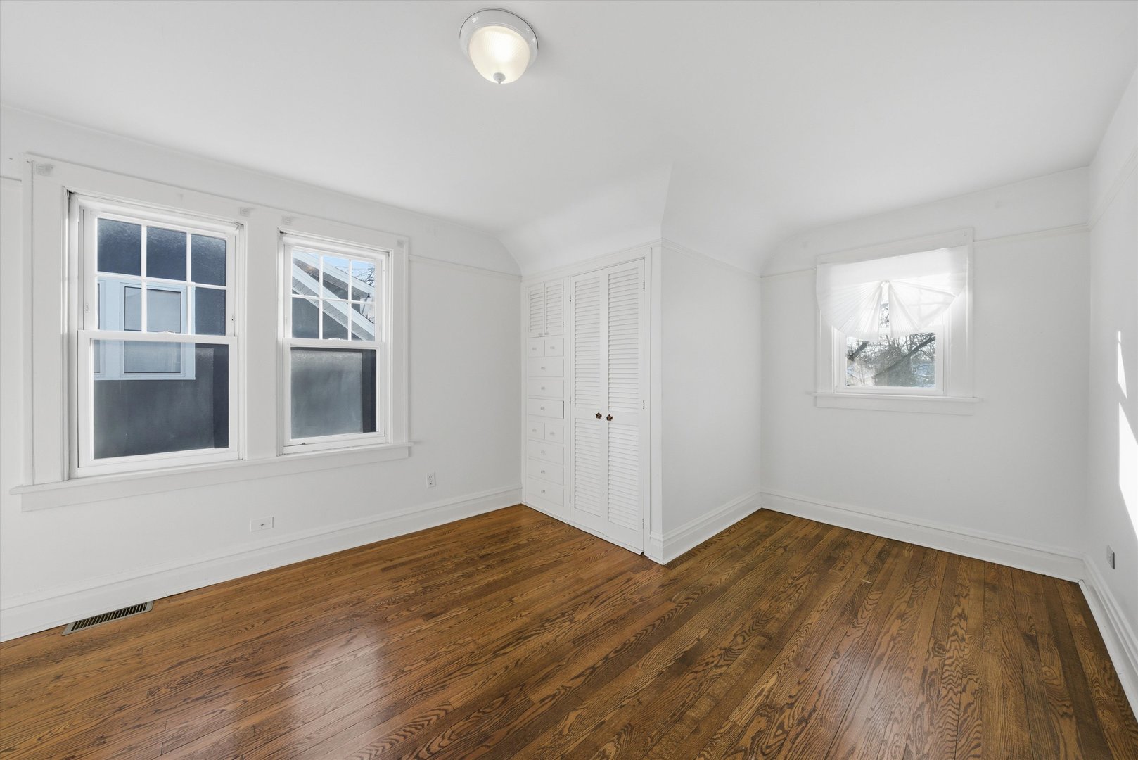 314 Elm Street Lombard, IL 60148 - Photo 17 of 43 a view of an empty room with wooden floor and a window
