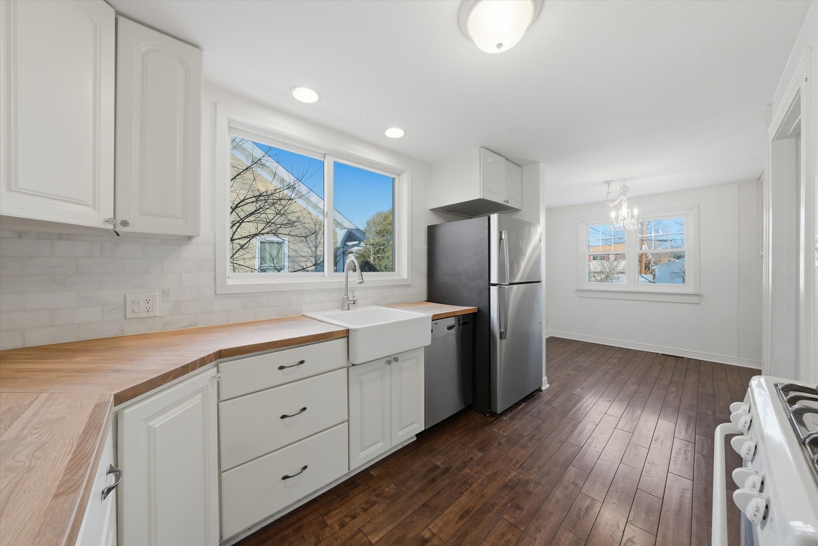 314 Elm Street Lombard, IL 60148 - Photo 20 of 43 a kitchen with stainless steel appliances granite countertop a refrigerator sink and wooden cabinets