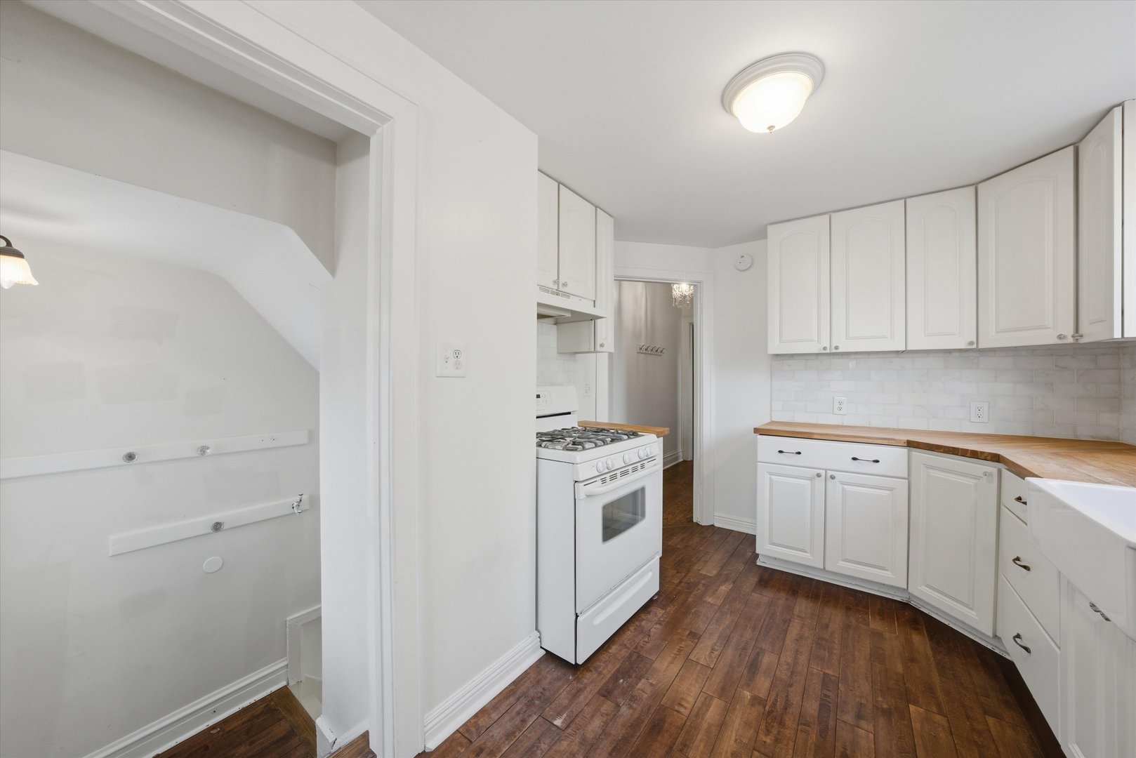 314 Elm Street Lombard, IL 60148 - Photo 21 of 43 a kitchen with cabinets stainless steel appliances and wooden floor