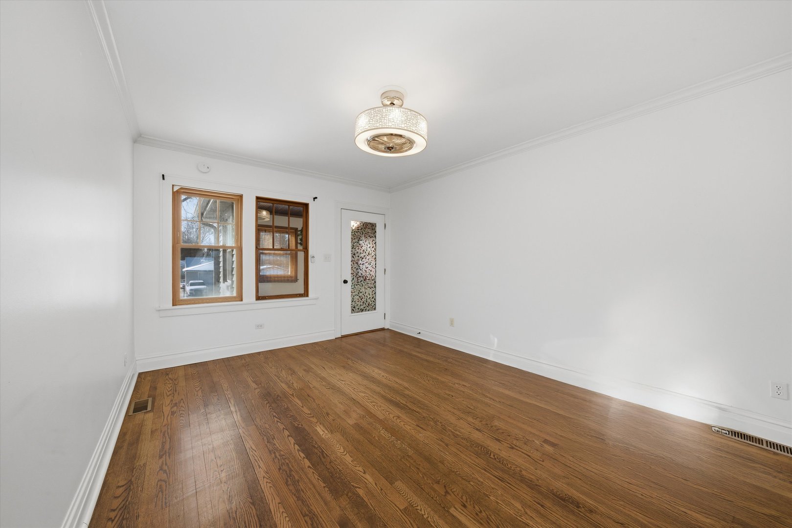 314 Elm Street Lombard, IL 60148 - Photo 5 of 43 an empty room with wooden floor cabinet and windows