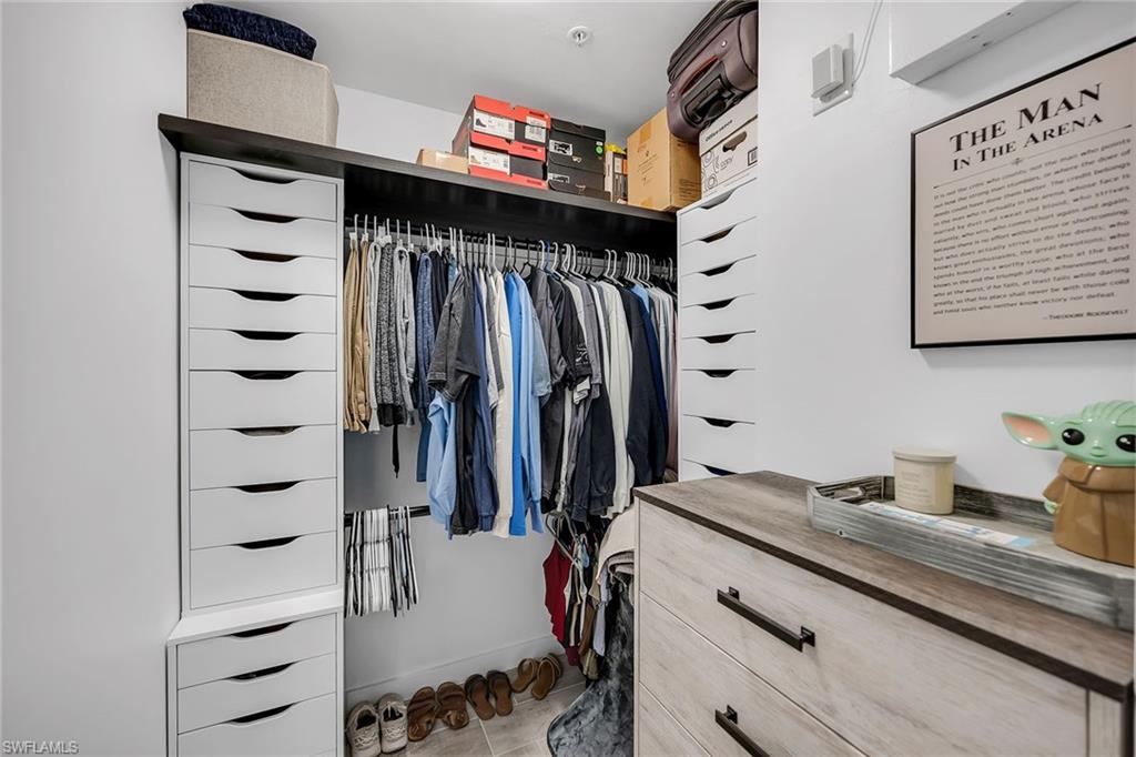4620 St Croix Lane, Unit 918 Naples, FL 34109 - Photo 13 of 43 a view of walk in closet with clothes and shoes