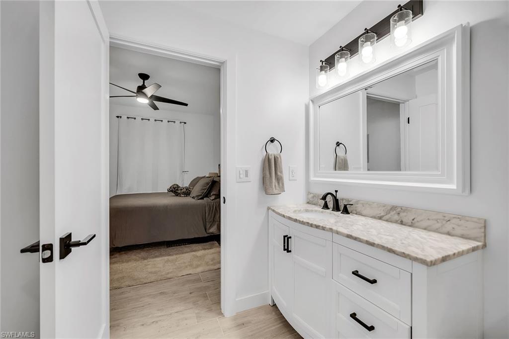 4620 St Croix Lane, Unit 918 Naples, FL 34109 - Photo 15 of 43 a bathroom with a granite countertop sink and a mirror