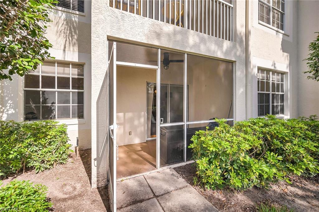 4620 St Croix Lane, Unit 918 Naples, FL 34109 - Photo 20 of 43 a view of a house with a yard and potted plants