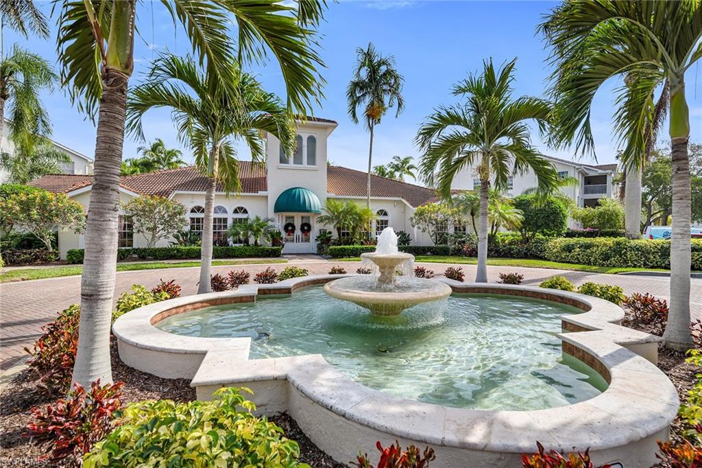 4620 St Croix Lane, Unit 918 Naples, FL 34109 - Photo 23 of 43 a view of a swimming pool with a table and chairs