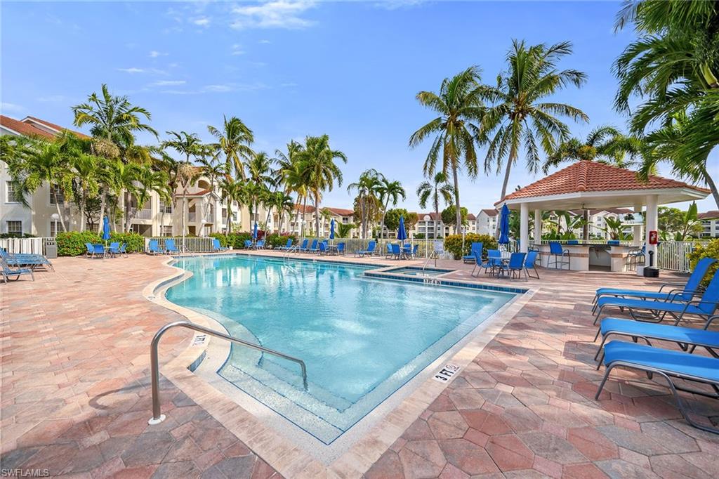 4620 St Croix Lane, Unit 918 Naples, FL 34109 - Photo 24 of 43 a view of swimming pool with outdoor seating and plants