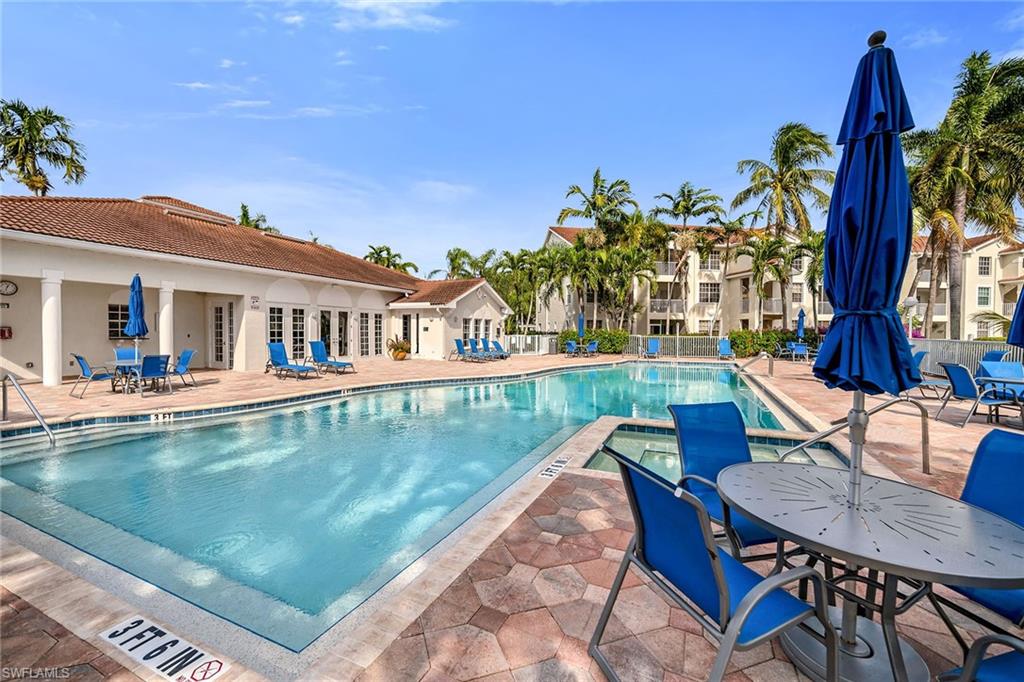 4620 St Croix Lane, Unit 918 Naples, FL 34109 - Photo 25 of 43 a view of swimming pool with outdoor seating