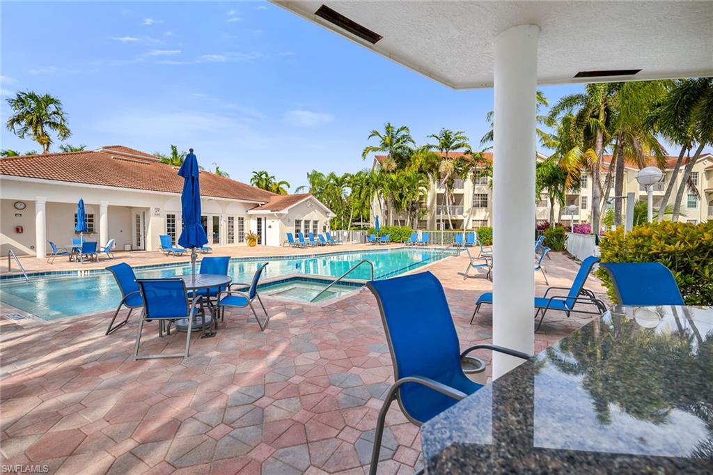 4620 St Croix Lane, Unit 918 Naples, FL 34109 - Photo 29 of 43 a view of a chairs and table in patio with a fire pit