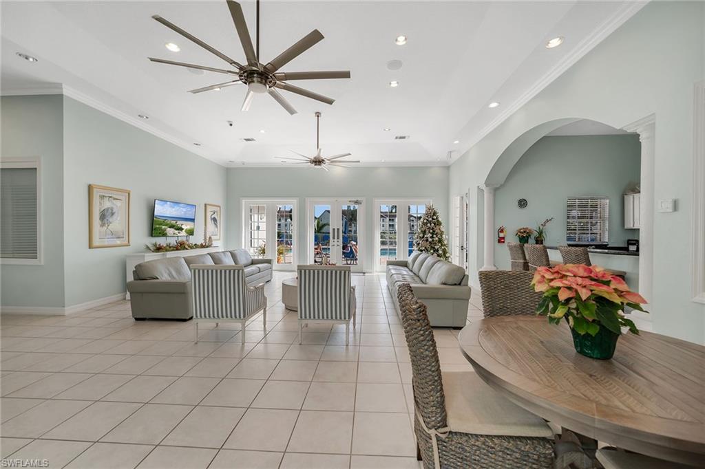 4620 St Croix Lane, Unit 918 Naples, FL 34109 - Photo 30 of 43 a living room with furniture and a chandelier